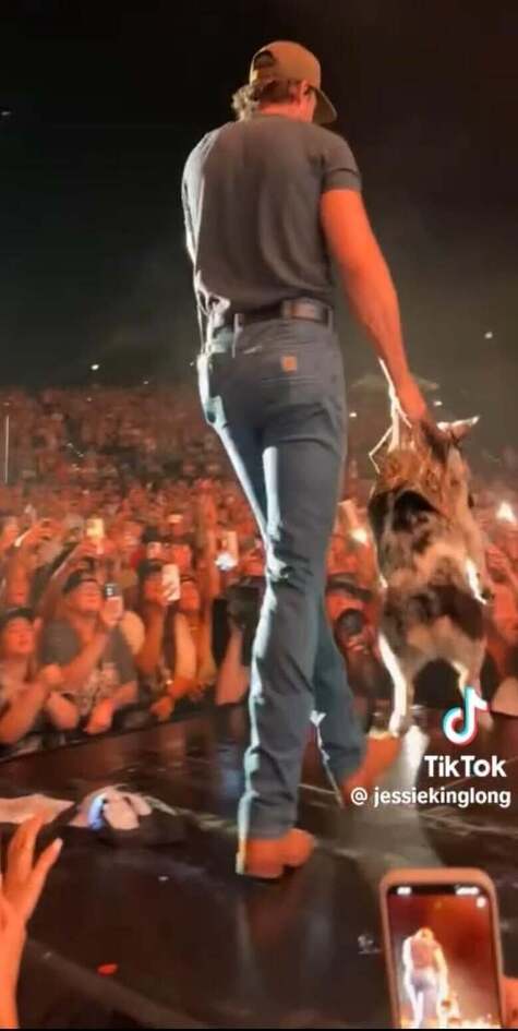 Riley Green on stage wearing Carhartt jeans. Americana Aspects.